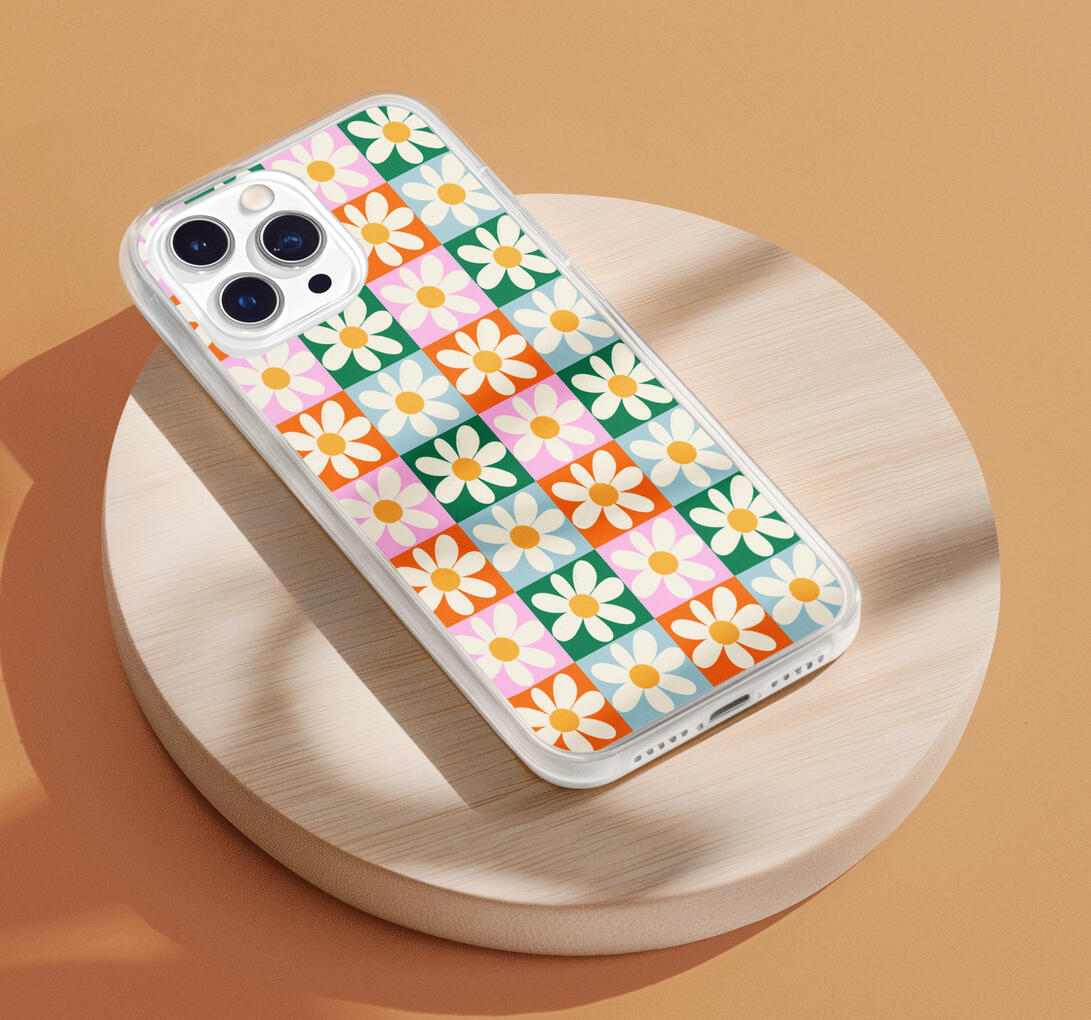 Fun retro pattern on checkerboard background in green, blue, pink and orange with hand drawn white flowers.
